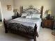 Serene main bedroom with a decorative metal bed frame, neutral bedding, and matching nightstands at 1921 Bell Creek Loop, Fruitland Park, FL 34731