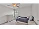 Neutral bedroom with ceiling fan, a window with blinds, and a dresser for storage at 2030 Country Manor St, Bartow, FL 33830