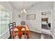 Cozy dining area with natural light, a charming chandelier, and views into the bedroom at 2030 Country Manor St, Bartow, FL 33830