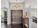 Grand foyer featuring a stylish light fixture, dark wood floors, and a view to the living spaces at 2030 Country Manor St, Bartow, FL 33830