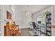 Cozy office area with a decorative light fixture, a bookshelf and a traditional piano at 2030 Country Manor St, Bartow, FL 33830