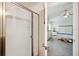 Bathroom leading into a bedroom, with walk-in shower and carpeted floors at 2085 Pecos Dr, Kissimmee, FL 34759