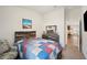 Bedroom featuring colorful quilt, weathered wood headboard, and view to hallway at 2085 Pecos Dr, Kissimmee, FL 34759