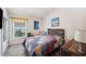 Comfortable bedroom features a rustic wood headboard and bright, colorful quilt at 2085 Pecos Dr, Kissimmee, FL 34759