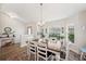 Bright and airy dining room with wood floors, stylish furniture, and an adjacent entry area at 2085 Pecos Dr, Kissimmee, FL 34759