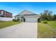 Attractive single-story house with landscaped yard and attached two-car garage with a long driveway at 2085 Pecos Dr, Kissimmee, FL 34759