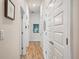 Bright hallway with wood floors and white doors offers a clean and modern aesthetic at 2085 Pecos Dr, Kissimmee, FL 34759