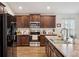 Modern kitchen featuring dark wood cabinetry, stainless steel appliances, and granite countertops at 2085 Pecos Dr, Kissimmee, FL 34759