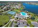 Community aerial view showcasing a pool, playground, tennis court, and clubhouse at 2210 Moraine Ct, Lakeland, FL 33805