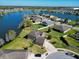 Scenic aerial view of lakefront homes with lush landscaping and ample green space at 2210 Moraine Ct, Lakeland, FL 33805