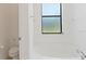 Clean bathroom featuring a soaking tub with chrome fixtures and a window at 2210 Moraine Ct, Lakeland, FL 33805