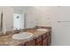 Bathroom featuring double sinks, granite counters, and plenty of vanity storage at 2210 Moraine Ct, Lakeland, FL 33805