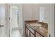 Bathroom with a granite-topped vanity and a glass-enclosed shower for a modern look at 2210 Moraine Ct, Lakeland, FL 33805