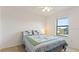 Bedroom featuring a patterned quilt and a sunlit window at 2210 Moraine Ct, Lakeland, FL 33805