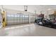 Spacious garage with epoxy flooring, overhead storage, and exercise equipment at 2210 Moraine Ct, Lakeland, FL 33805