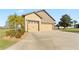 Spacious three-car garage and driveway surrounded by lush green lawn, ample parking for residents and visitors at 2210 Moraine Ct, Lakeland, FL 33805