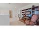 Bright hallway featuring a dark wood bookcase and rocking chairs at 2210 Moraine Ct, Lakeland, FL 33805