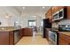 Modern kitchen equipped with granite countertops and stainless steel appliances, seamlessly connecting to the dining area at 2210 Moraine Ct, Lakeland, FL 33805