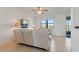 Comfortable living room with tile floors, a ceiling fan, and a large window overlooking the water at 2210 Moraine Ct, Lakeland, FL 33805