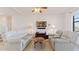 Bright living room with tile floors, ceiling fan, and a large TV at 2210 Moraine Ct, Lakeland, FL 33805