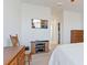 Bedroom showcasing a dresser, TV, and a peek into the ensuite bathroom at 2210 Moraine Ct, Lakeland, FL 33805