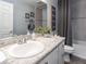 Bathroom with a white single sink vanity, gray tile accents, and a shower-tub combination at 2335 Northumberland Ct, Haines City, FL 33844