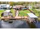 Aerial shot of a well-maintained property with a pool, dock, and waterfront access at 27836 Lois Dr, Tavares, FL 32778