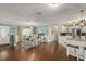 Open concept dining room features dark hardwood flooring, natural light, and connection to the kitchen at 27836 Lois Dr, Tavares, FL 32778