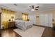 Bedroom featuring a ceiling fan, hardwood floors, a decorative rug, and neutral-colored walls at 27836 Lois Dr, Tavares, FL 32778