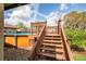 Pool deck stairs leading to an above ground pool with fence and landscaping at 27836 Lois Dr, Tavares, FL 32778