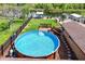 Aerial view of the backyard featuring an above ground pool with deck, boat dock, gazebo and lush landscaping at 27836 Lois Dr, Tavares, FL 32778