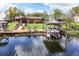 Stunning waterfront view with a private dock, boat lift, and relaxing lounge chairs at 27836 Lois Dr, Tavares, FL 32778