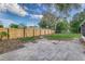 A view of the backyard featuring a wooden fence and a concrete patio extending from the house at 2924 Bellwood Ave, Lakeland, FL 33803