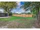 Spacious backyard featuring a new wooden fence and a mix of greenery and shade at 2924 Bellwood Ave, Lakeland, FL 33803