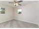 Bedroom showcasing gray carpet, a fan, and a window for natural light at 2924 Bellwood Ave, Lakeland, FL 33803