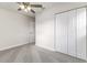 Carpeted bedroom with a fan, closet, and view to other rooms at 2924 Bellwood Ave, Lakeland, FL 33803