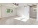 Bright bedroom featuring tile flooring, a barn door closet, and a ceiling fan at 2924 Bellwood Ave, Lakeland, FL 33803