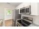 Modern kitchen featuring stainless steel appliances, white cabinets, granite countertops, and subway tile backsplash at 2924 Bellwood Ave, Lakeland, FL 33803