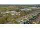 An aerial view of a residential area near a golf course, school, and shopping center under a clear blue sky at 2987 Mission Lakes Dr # 10, Lakeland, FL 33803