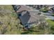 An aerial view of a well-maintained home with a dark roof and lush green lawn in a suburban neighborhood at 2987 Mission Lakes Dr # 10, Lakeland, FL 33803