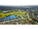 An aerial view shows a charming lakeside community with lush green spaces and a serene ambiance on a sunny day at 2987 Mission Lakes Dr # 10, Lakeland, FL 33803