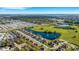 An aerial view features a community with picturesque lake views, lush greenery, and well-maintained landscaping on a sunny day at 2987 Mission Lakes Dr # 10, Lakeland, FL 33803