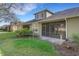 View of the backyard with a covered patio and green lawn at 2987 Mission Lakes Dr # 10, Lakeland, FL 33803