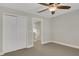 Bedroom featuring a ceiling fan, closet, and doorway leading to the hallway at 2987 Mission Lakes Dr # 10, Lakeland, FL 33803