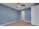 Blue Bedroom featuring ceiling fan, doors to other rooms and carpeted floors at 2987 Mission Lakes Dr # 10, Lakeland, FL 33803