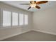 Simple bedroom with a ceiling fan and plantation shutters at 2987 Mission Lakes Dr # 10, Lakeland, FL 33803