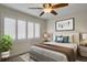 Cozy bedroom with a ceiling fan, plantation shutters, and a queen-sized bed at 2987 Mission Lakes Dr # 10, Lakeland, FL 33803