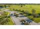 View of the elegant community entrance, featuring decorative signage, landscaping, and a paved road leading into the neighborhood at 2987 Mission Lakes Dr # 10, Lakeland, FL 33803