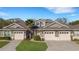 Attractive townhome featuring a well-maintained lawn, front garden, and spacious two-car garages at 2987 Mission Lakes Dr # 10, Lakeland, FL 33803