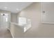 Bright hallway featuring neutral paint, white trim, and an open stairway at 2987 Mission Lakes Dr # 10, Lakeland, FL 33803